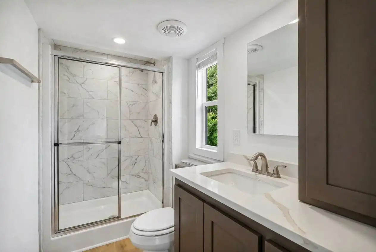 The Loft - bathroom with tiled shower and stone vanity