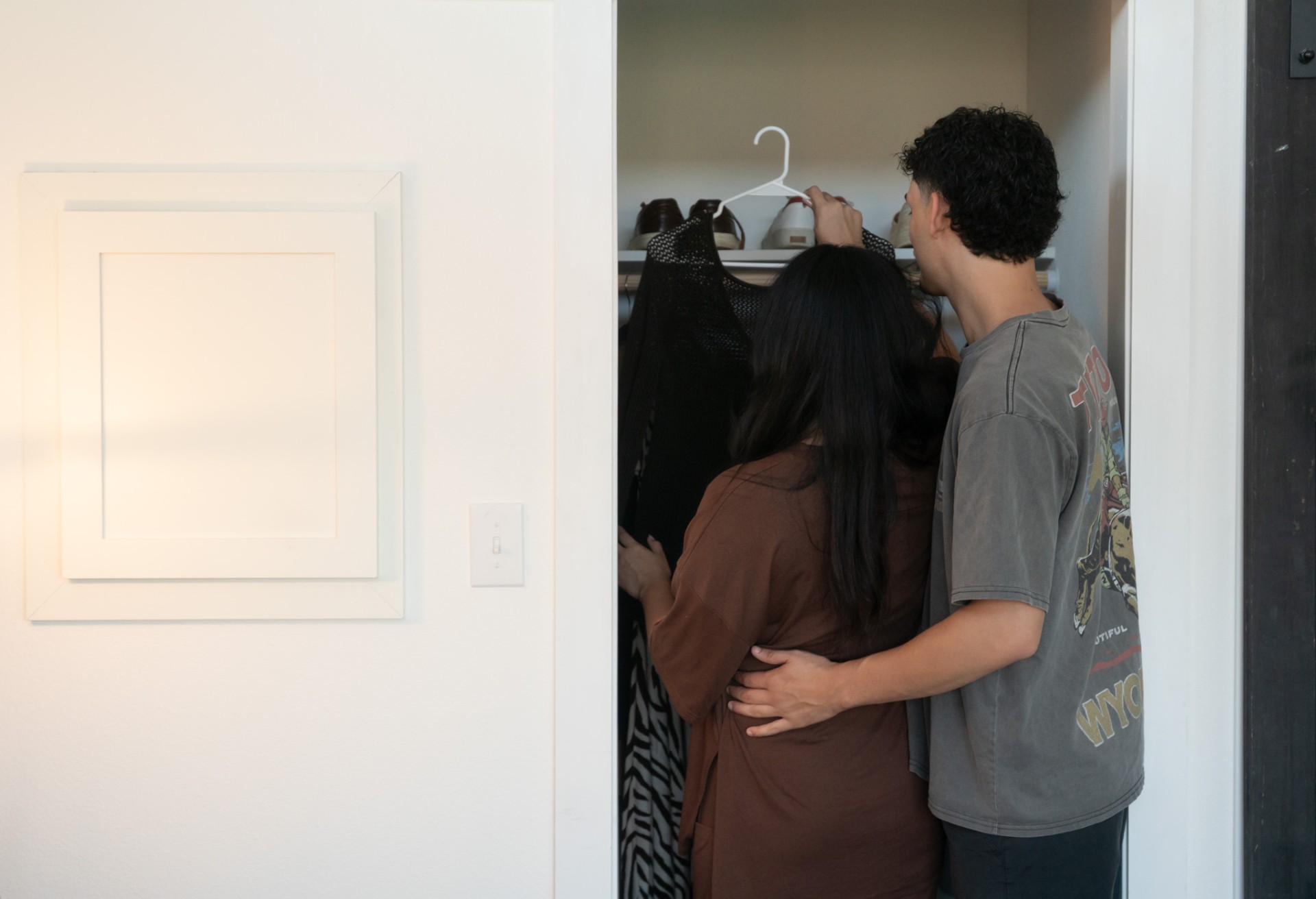 Couple exploring closet space