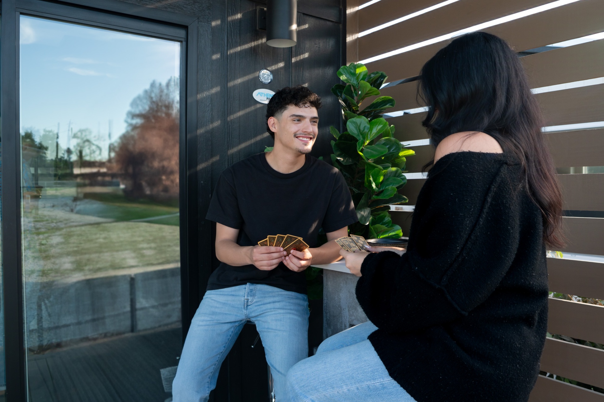 Young couple playing cards on porch