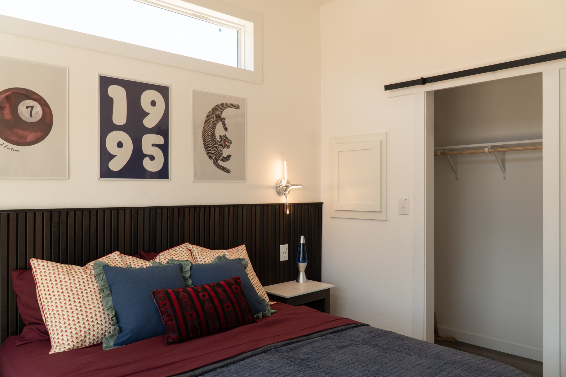 Stylish bedroom with art and barn door