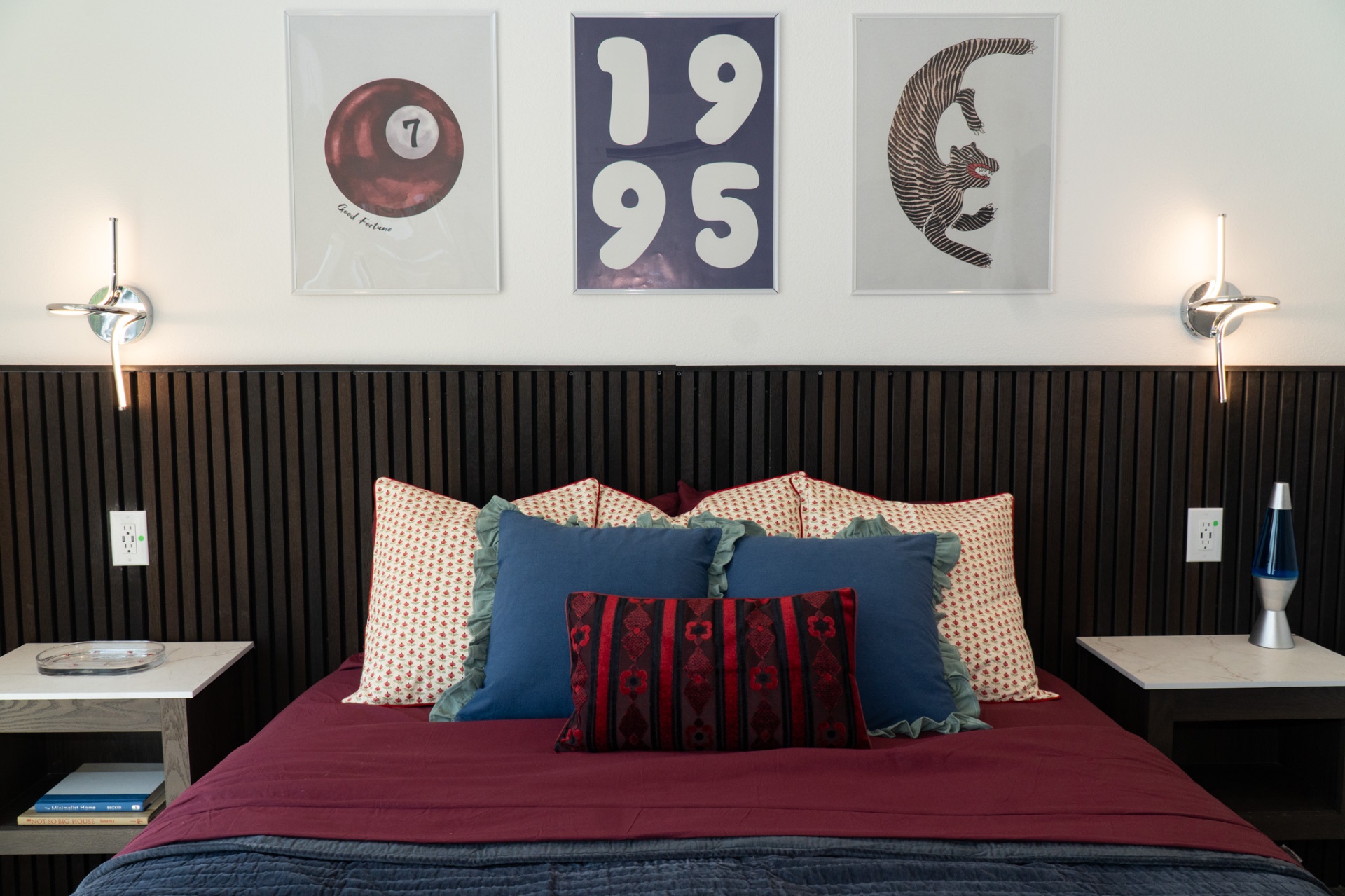 Bedroom with art and slatted headboard wall